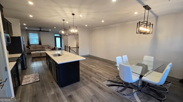 a view of a dining room with furniture and a chandelier