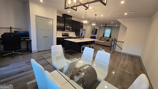 a large kitchen with a table and chairs
