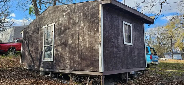 a living room with furniture a air conditioner vent and a window