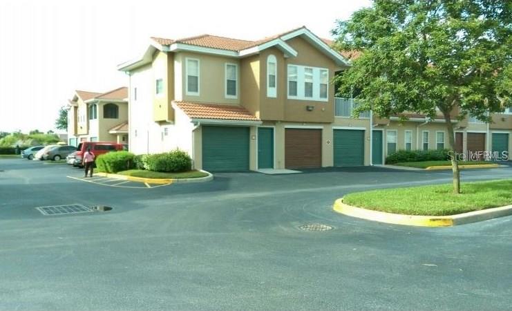 12204 Wild Iris Way, Unit 103 Orlando, FL 32837 - Photo 1 of 1 a front view of a house with a yard