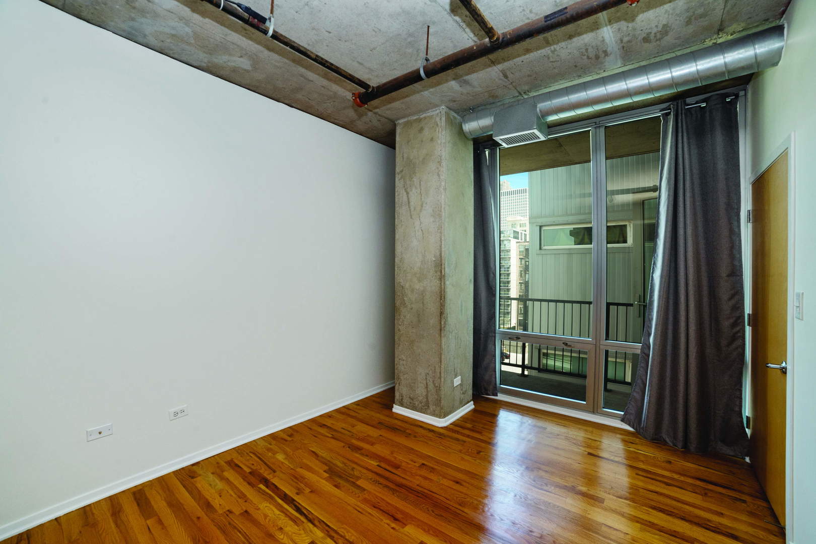 700 West Van Buren Street, Unit 1010 Chicago, IL 60607 - Photo 6 of 12 a view of empty room with wooden floor and fan