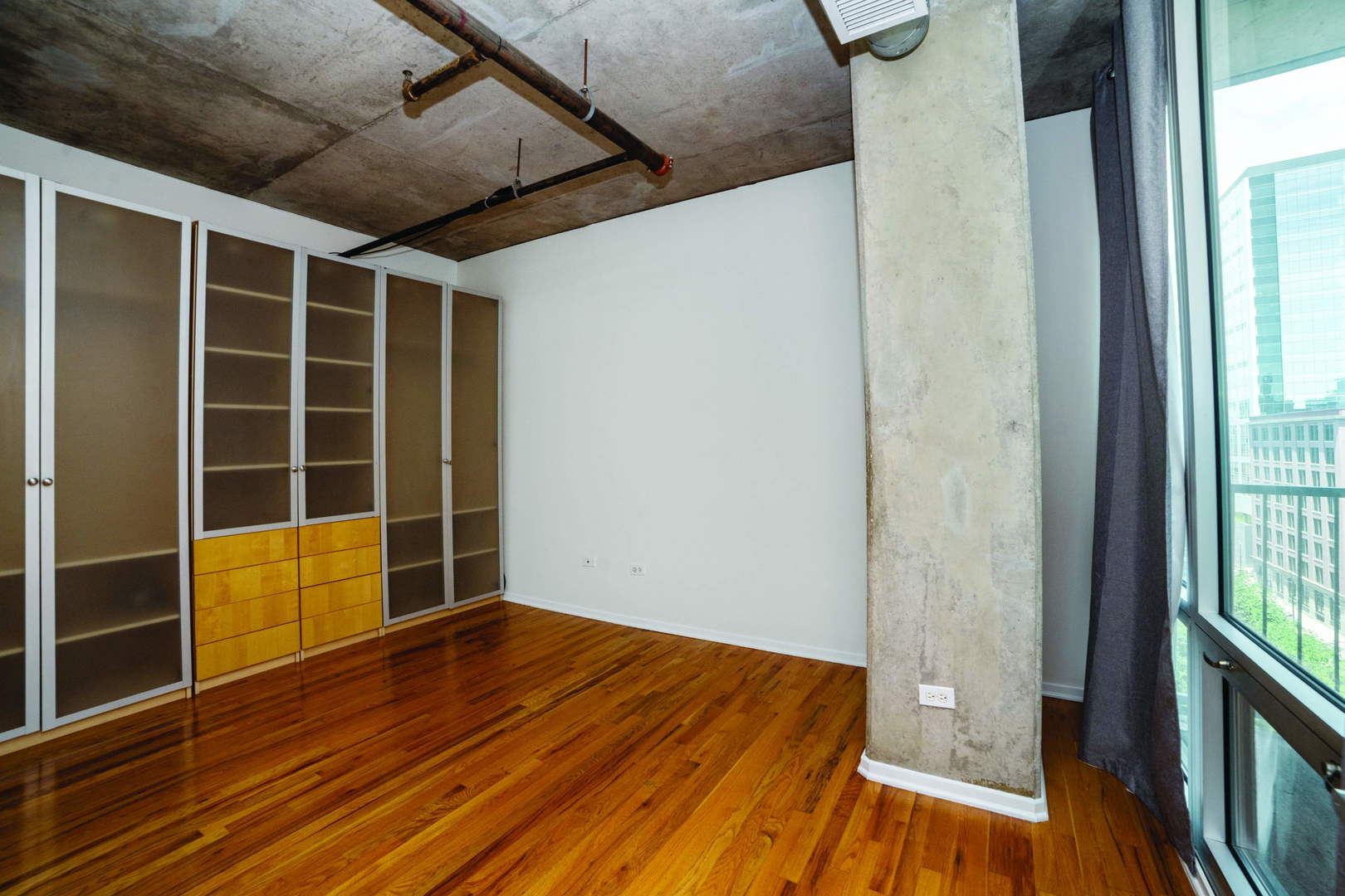 700 West Van Buren Street, Unit 1010 Chicago, IL 60607 - Photo 8 of 12 a view of empty room with wooden floor and windows