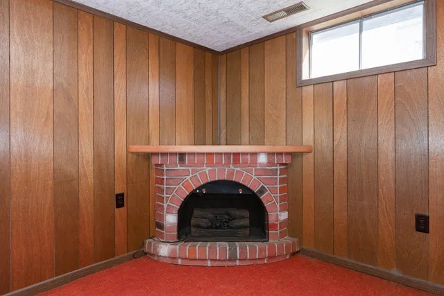 a living room with furniture a window and a fireplace