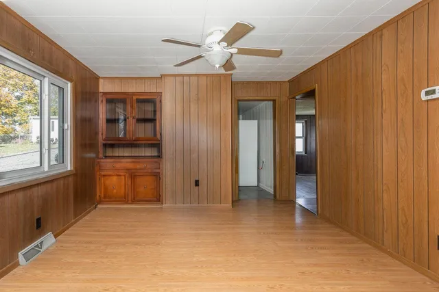 an empty room with closet and windows