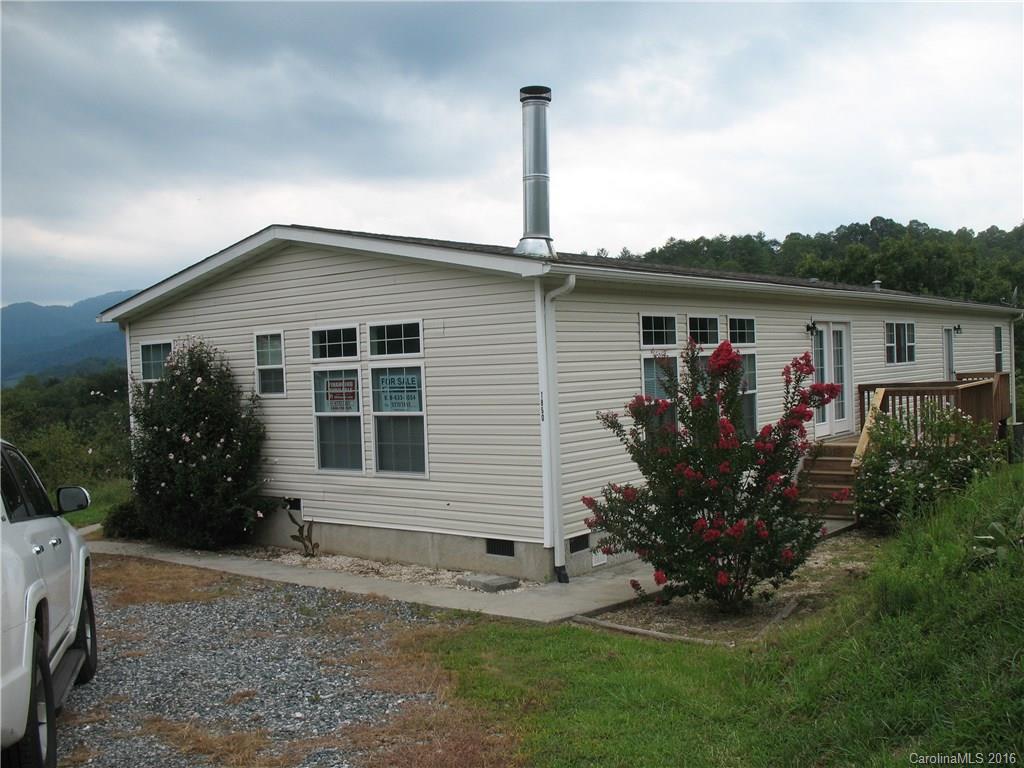 1890 Redmon Road Marshall, NC 28753 - Photo 1 of 16 a front view of house with a garden
