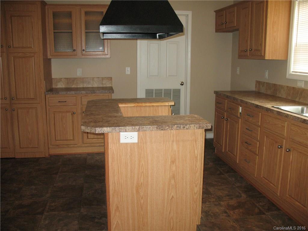 1890 Redmon Road Marshall, NC 28753 - Photo 14 of 16 a kitchen with a stove and a cabinets