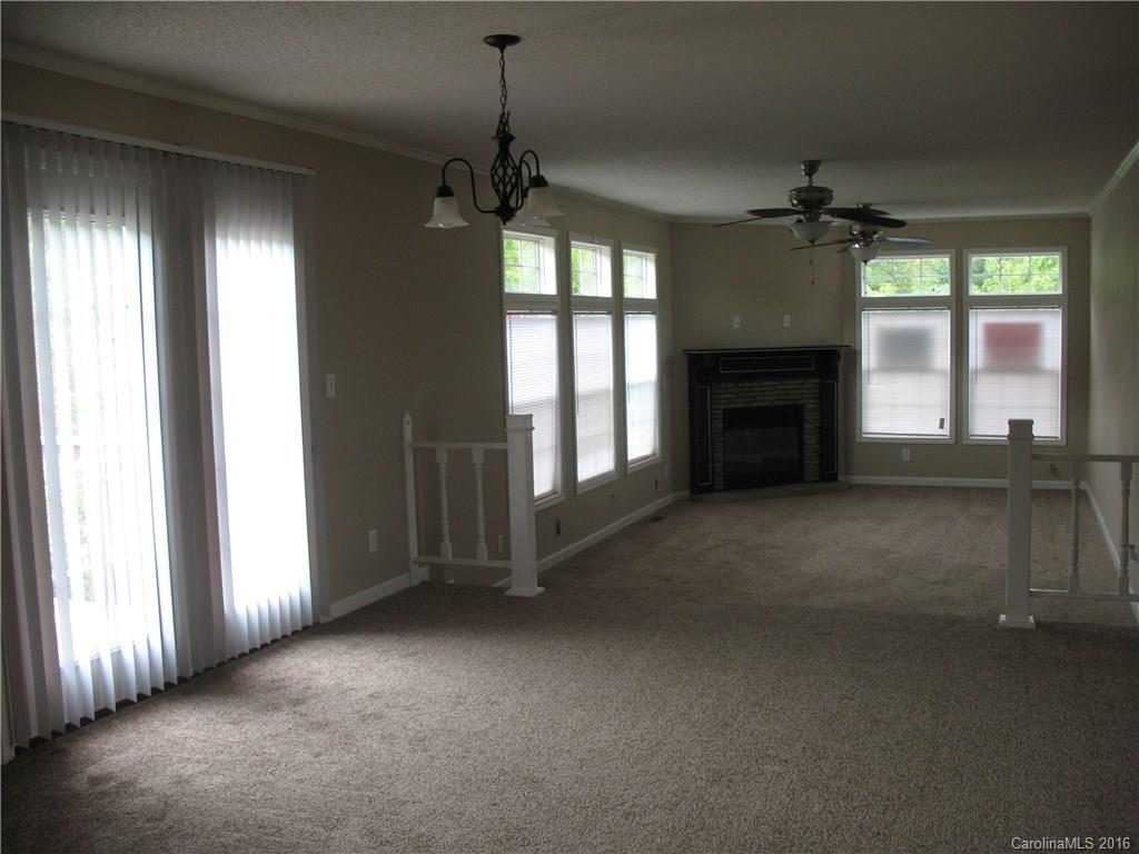 1890 Redmon Road Marshall, NC 28753 - Photo 4 of 16 an empty room with windows and fireplace
