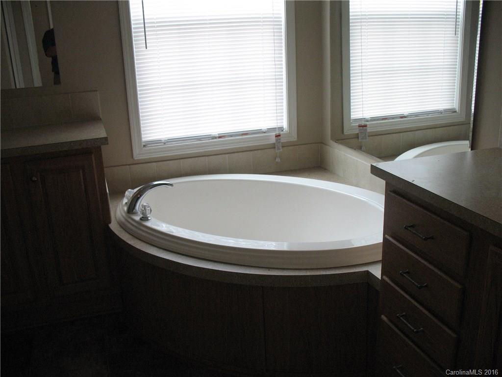 1890 Redmon Road Marshall, NC 28753 - Photo 7 of 16 a bathroom with a sink and a bathtub