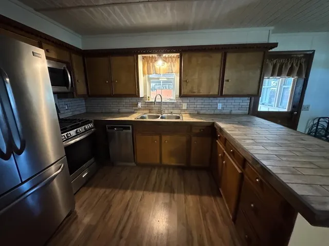 a kitchen with a sink stove and refrigerator