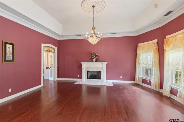 a view of a livingroom with hardwood floor and staircase
