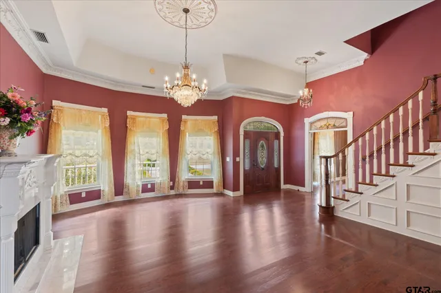 a view of a livingroom with wooden floor and a ceiling fan