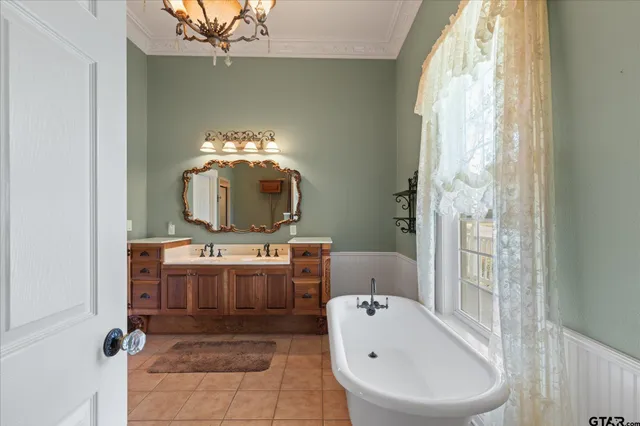 a large white kitchen with granite countertop a large window