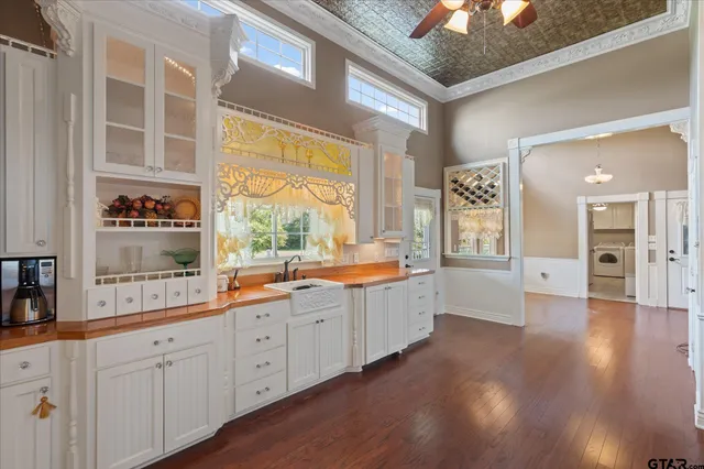 a view of a hallway with wooden floor and chandelier