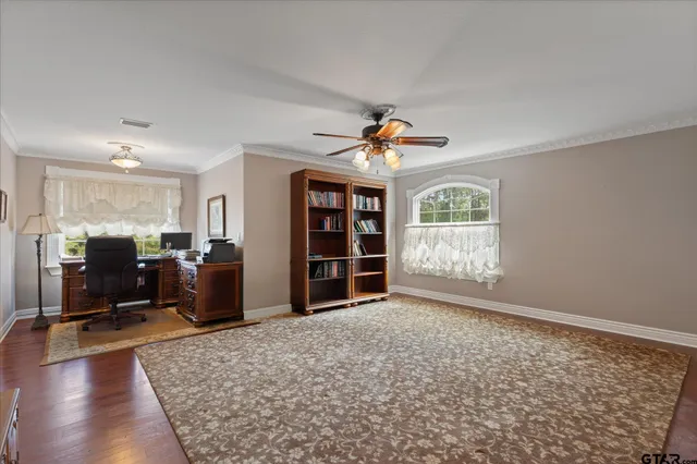 a view of a house with a big yard and large trees