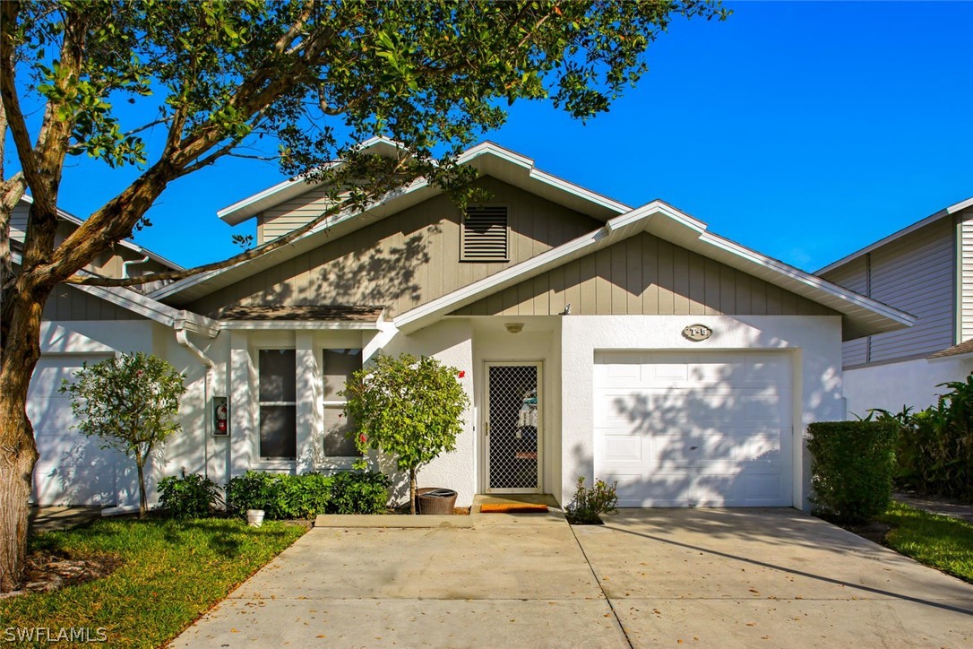 13710 Raleigh Lane, Unit 5 Fort Myers, FL 33919 - Photo 1 of 29 a front view of a house with garden