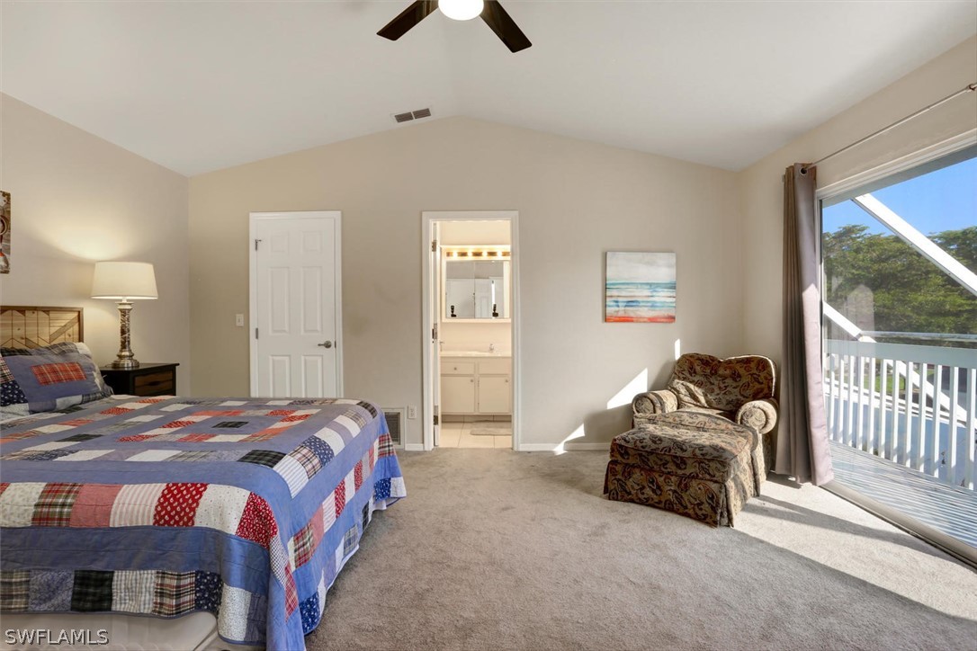 13710 Raleigh Lane, Unit 5 Fort Myers, FL 33919 - Photo 13 of 29 a bedroom with a bed and a chandelier