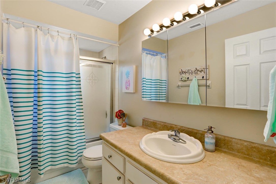13710 Raleigh Lane, Unit 5 Fort Myers, FL 33919 - Photo 17 of 29 a bathroom with a sink toilet and shower