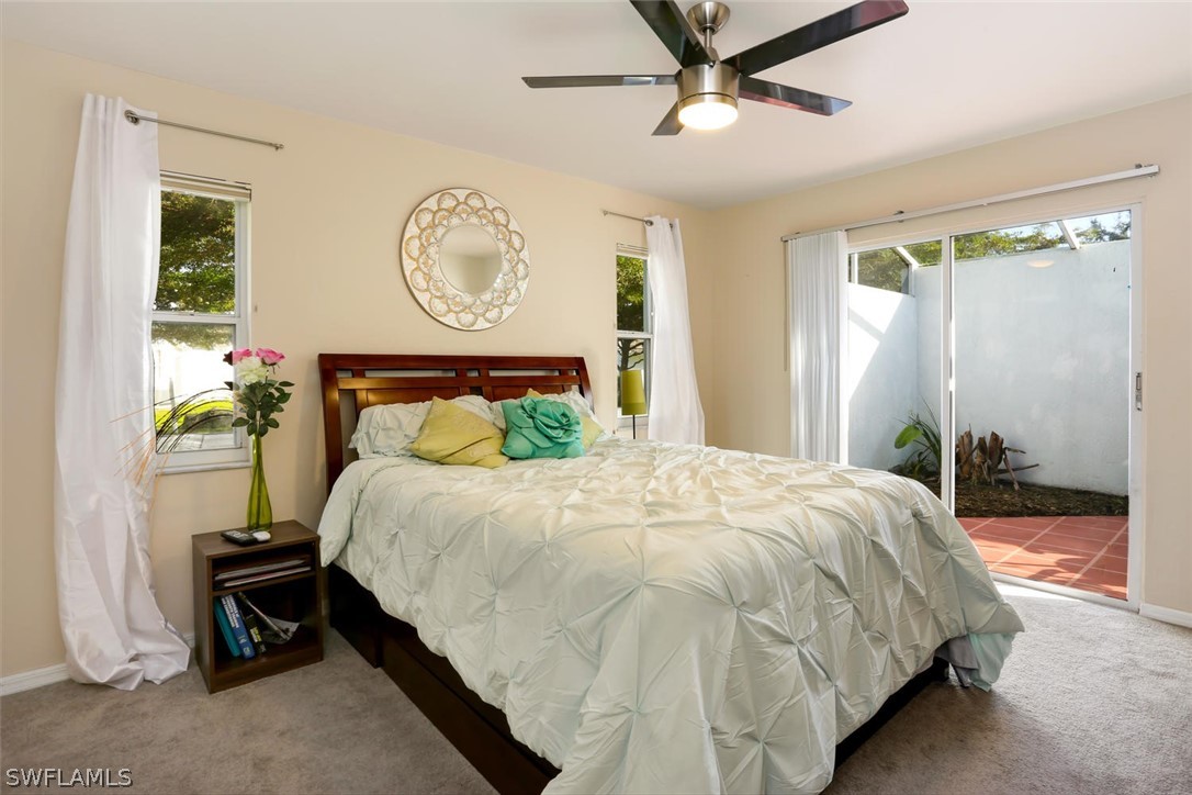 13710 Raleigh Lane, Unit 5 Fort Myers, FL 33919 - Photo 18 of 29 a bedroom with a bed mirror and a window