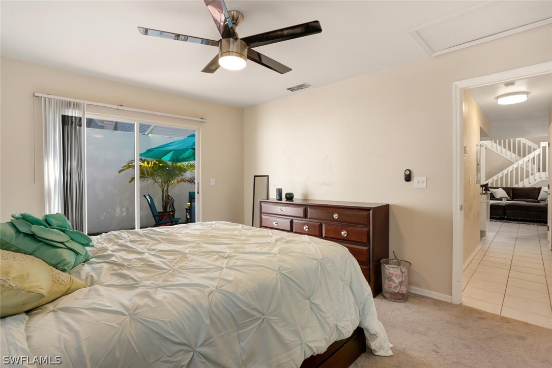 13710 Raleigh Lane, Unit 5 Fort Myers, FL 33919 - Photo 19 of 29 a bedroom with a bed and a chandelier