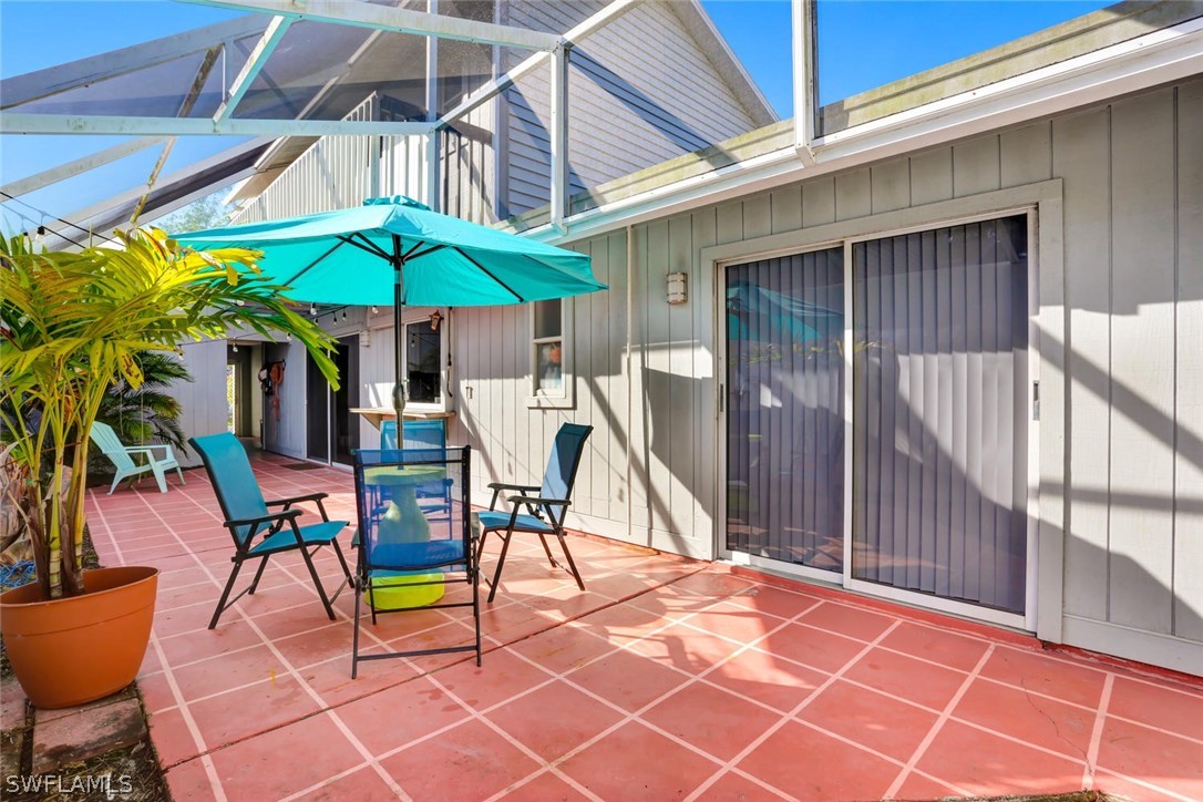 13710 Raleigh Lane, Unit 5 Fort Myers, FL 33919 - Photo 21 of 29 a patio with a table and chairs