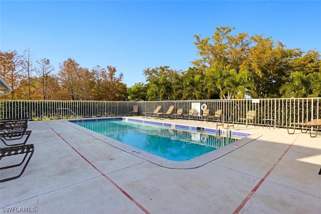 13710 Raleigh Lane, Unit 5 Fort Myers, FL 33919 - Photo 28 of 29 a view of a swimming pool with a patio and a yard