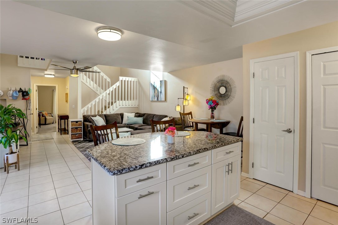 13710 Raleigh Lane, Unit 5 Fort Myers, FL 33919 - Photo 9 of 29 a kitchen with granite countertop a sink a counter and cabinets