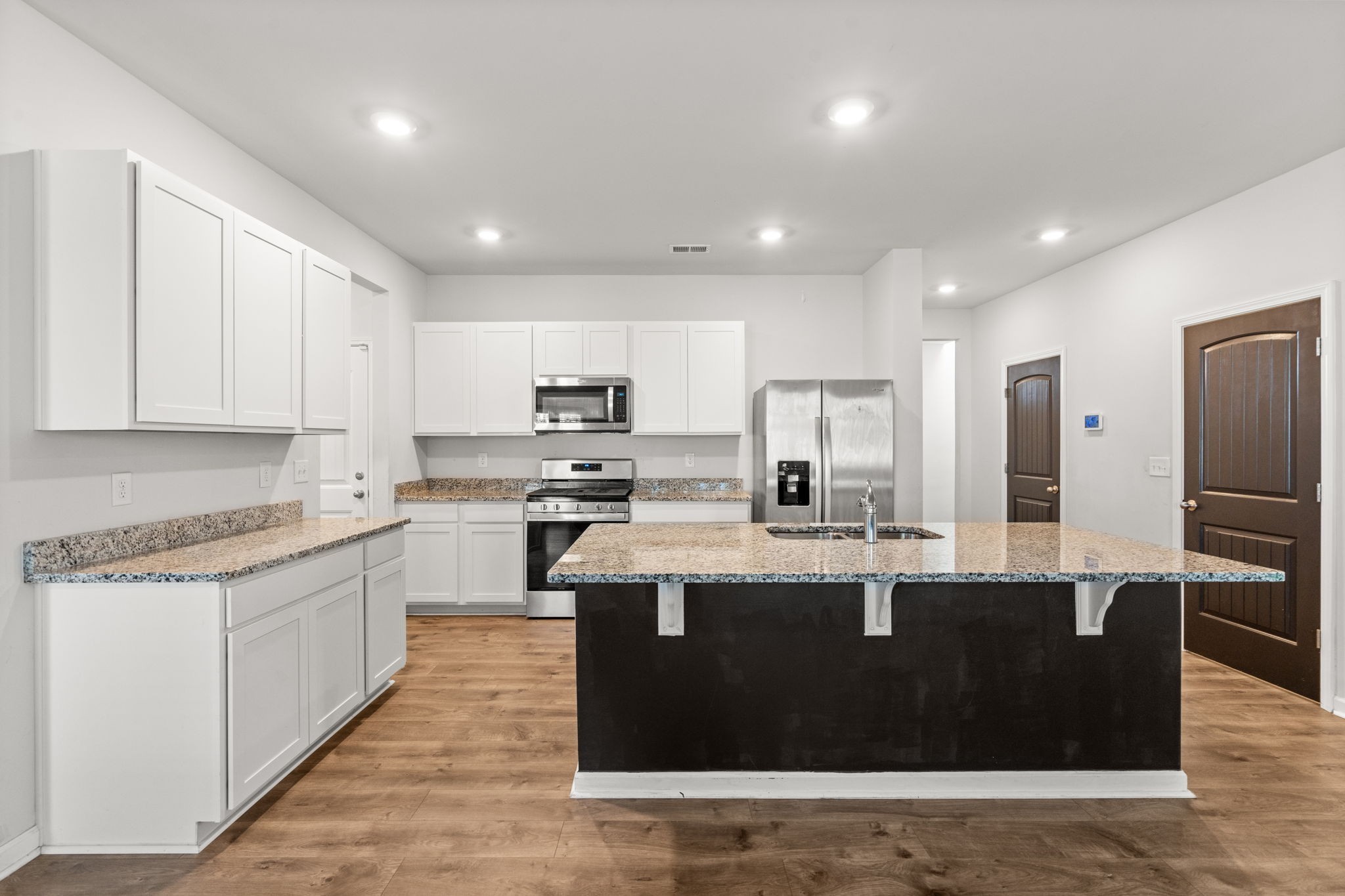 230 Willy Mae Road Murfreesboro, TN 37129 - Photo 4 of 23 a large kitchen with kitchen island a sink a stove and cabinets