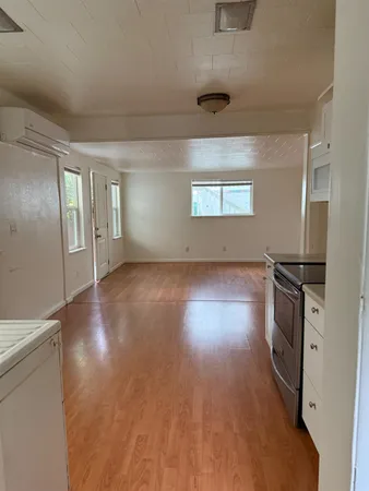 a kitchen with stainless steel appliances a sink window and cabinets