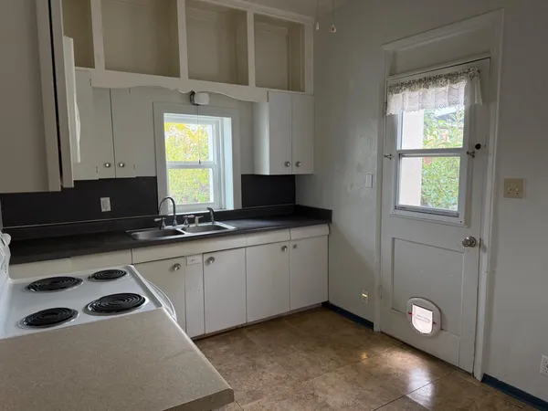 a kitchen with a sink cabinets and window