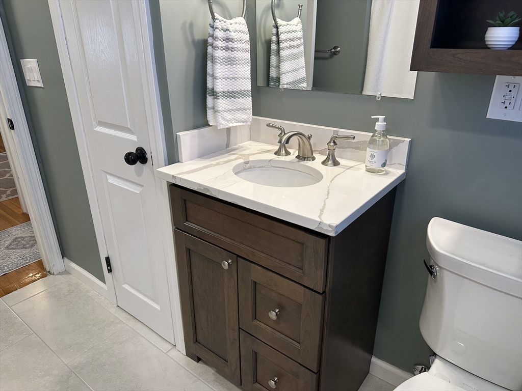254 Hartwick Street Springfield, MA 01108 - Photo 12 of 17 a bathroom with a sink toilet and mirror