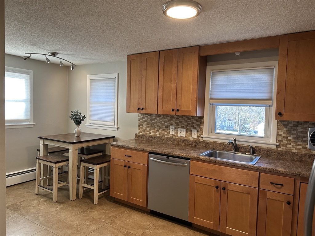 254 Hartwick Street Springfield, MA 01108 - Photo 4 of 17 a kitchen with stainless steel appliances granite countertop a sink and a cabinets