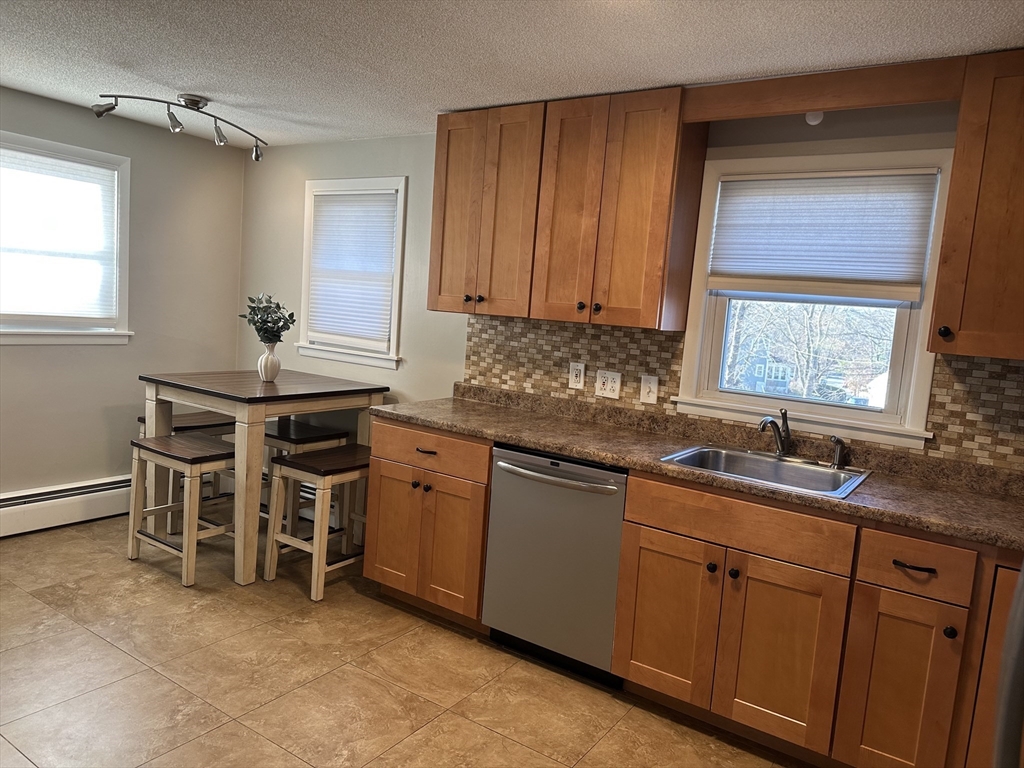 254 Hartwick Street Springfield, MA 01108 - Photo 5 of 17 a kitchen with stainless steel appliances granite countertop a sink and cabinets