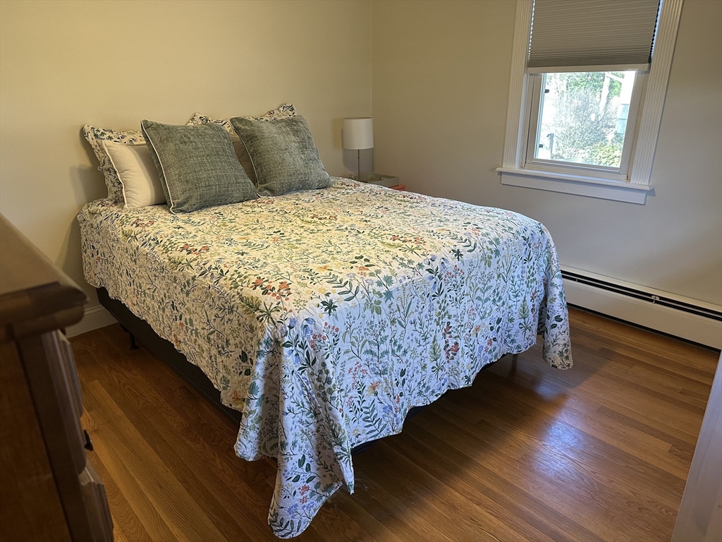 254 Hartwick Street Springfield, MA 01108 - Photo 8 of 17 a bed sitting in a bedroom next to a window