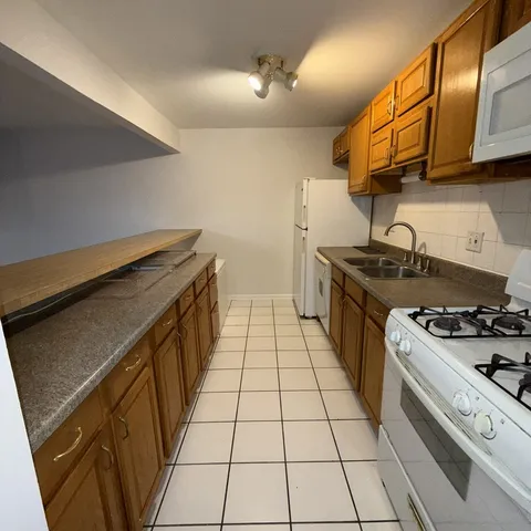 a kitchen with a stove a sink and dishwasher