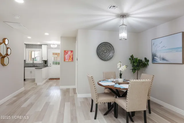 a view of a dining room with furniture and a chandelier