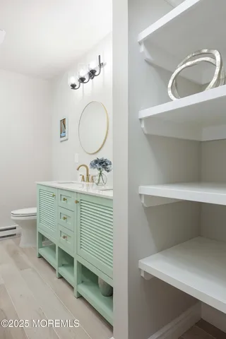 a bathroom with a double vanity sink mirror and toilet