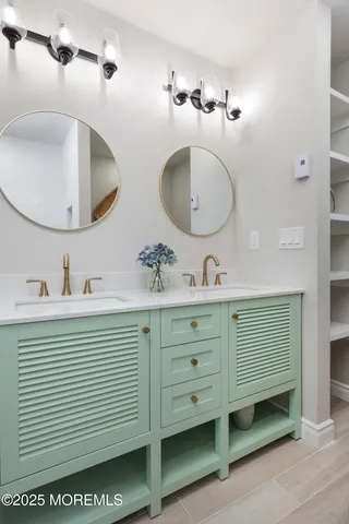 a bathroom with a double vanity sink and a mirror