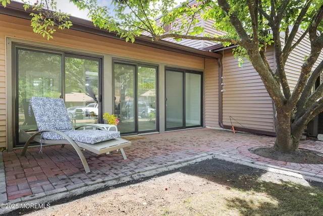 an aerial view of residential houses with outdoor space and lake view