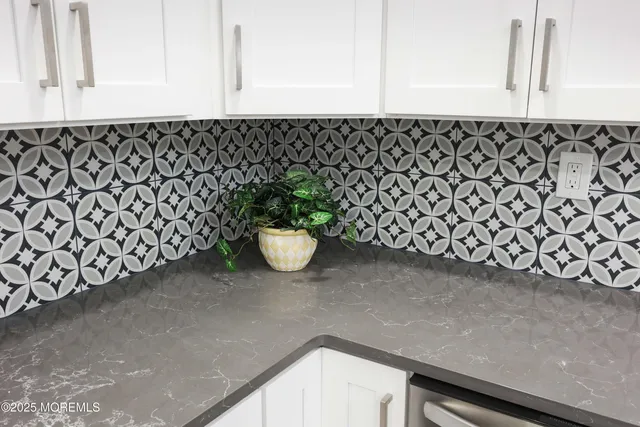 a close view of a sink a mirror and cabinets