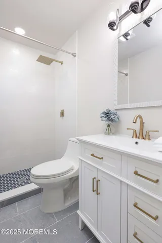 a bathroom with a sink toilet and shower