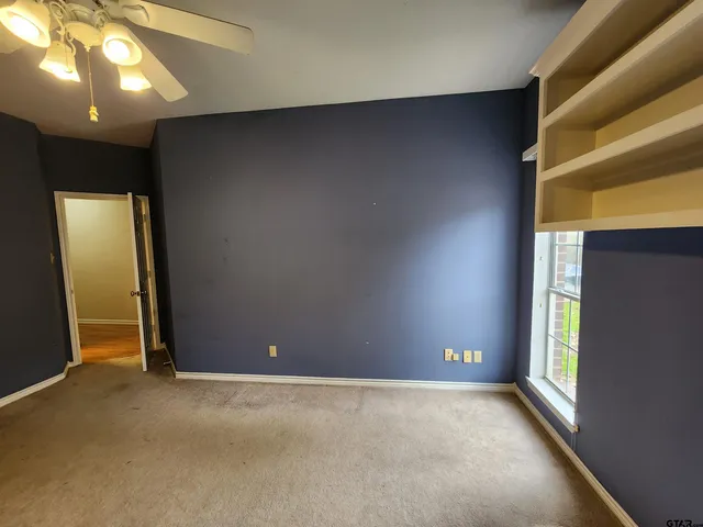 an empty room with closet area