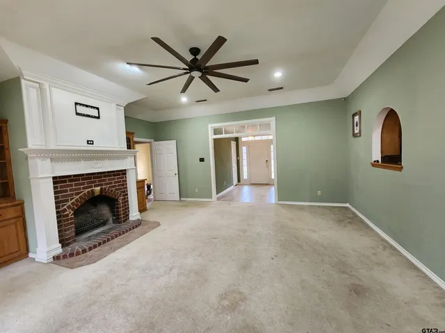 a view of a livingroom with a fireplace and a window