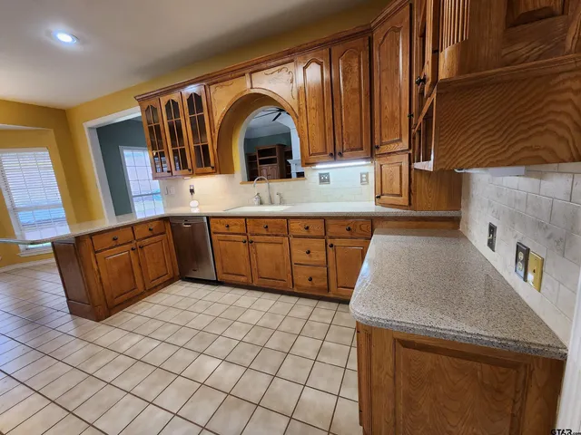 a kitchen with stainless steel appliances a sink stove and cabinets