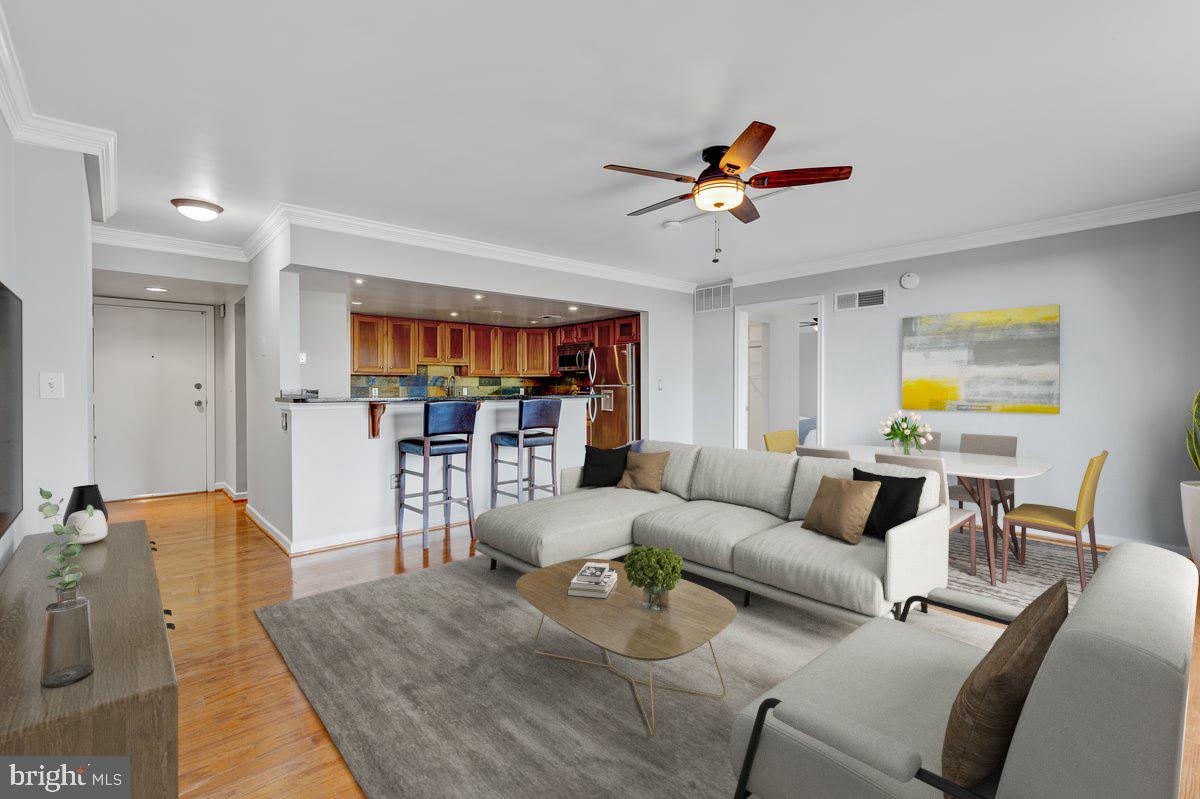 a living room with furniture a ceiling fan and a rug