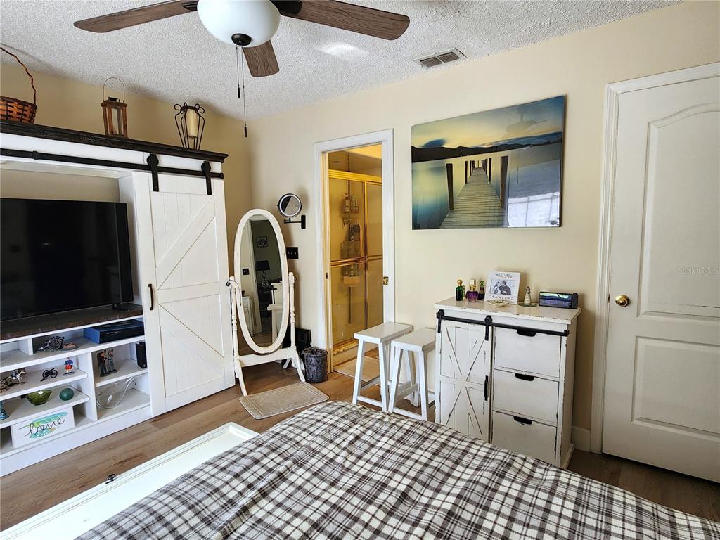 1701 Southeast 24th Road, Unit 1601 Ocala, FL 34471 - Photo 13 of 30 a room with furniture a flat screen tv and cabinets