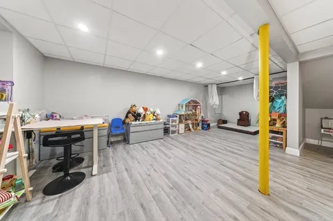 a view of a room with furniture and wooden floor