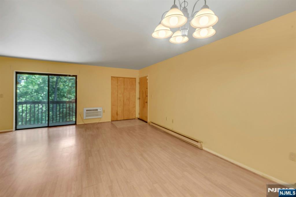 666 Mill Street, Unit C6 Belleville, NJ 07109 - Photo 3 of 25 an empty room with wooden floor and windows