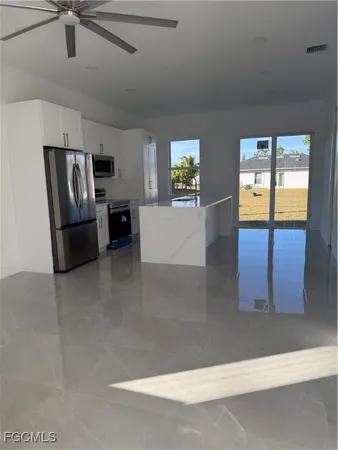 a view of a livingroom with furniture and staircase