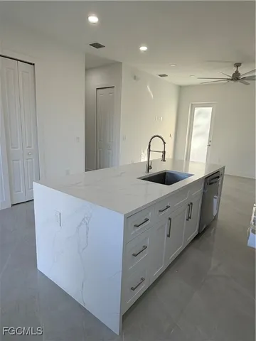 a kitchen with kitchen island a refrigerator sink and microwave
