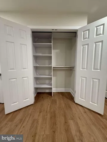 a view of a room with wooden floor